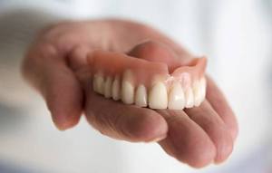 Dentures on a palm